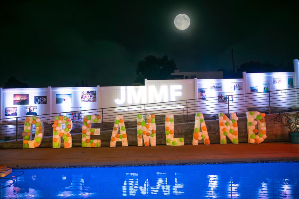 2024 Benefiesta Dreamland sign under the bright moon